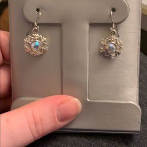 Silver colored snow flake hanging earrings.